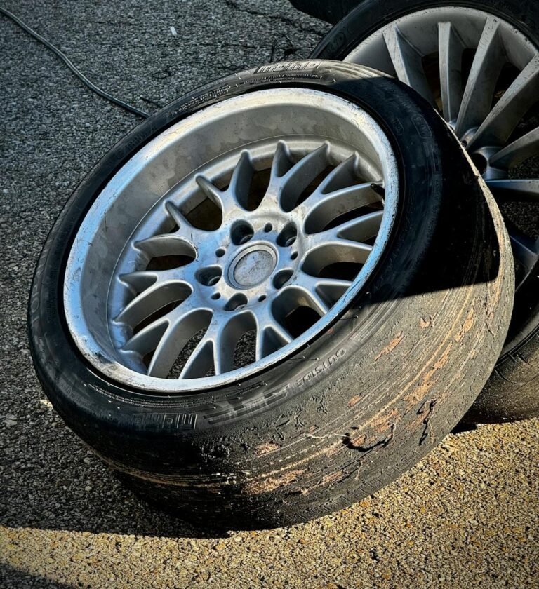 a tire and rim sitting on the ground